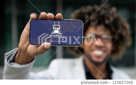 Positive handsome young african american guy entrepreneur showing horizontal phone with chatbot application on screen. Businessman using artificial intelligence in business process, collage Positive handsome young african american guy entrepreneur showing horizontal phone with chatbot application on screen. Businessman using artificial intelligence in business process, collage 115637208