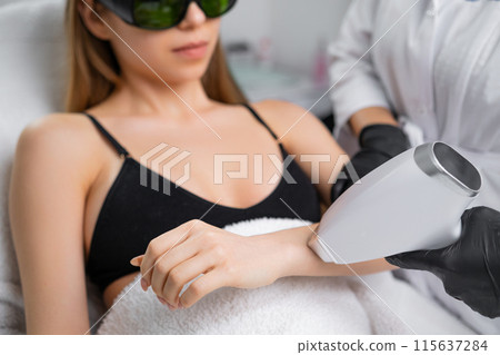 Woman attains hair free arms with the help of laser hair removal technology 115637284