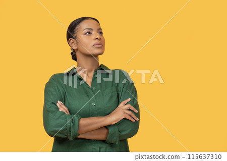 Female Confidence. African American Woman Posing With Confident Expression, Crossing Hands On Chest And Looking Aside At Empty Space For Text Standing Over Yellow Background, Studio Shot Female Confidence. African American Woman Posing With Confident Expression, Crossing Hands On Chest And Looking Aside At Empty Space For Text Standing Over Yellow Background, Studio Shot 115637310