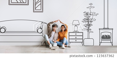 Family Housing. Cheerful Asian Young Couple Dreaming About New Home, Joining Hands Like House Roof Above Them, Sitting Near White Wall With Illustration Of Living Room Interior. Collage, Panorama 115637362