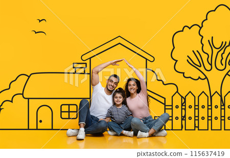 Middle eastern family consisting of parents and daughter sit on the floor. In front of them is a large drawing of a house, possibly a dream home. They appear to be discussing or admiring the artwork. Middle eastern family consisting of parents and daughter sit on the floor. In front of them is a large drawing of a house, possibly a dream home. They appear to be discussing or admiring the artwork. 115637419