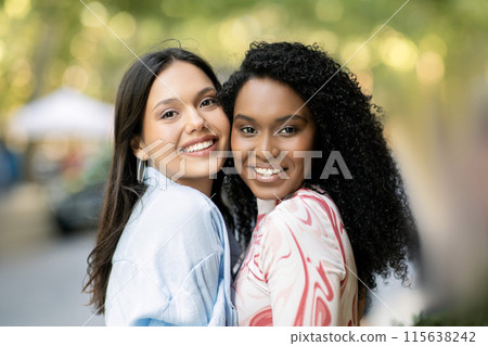 Friendship Concept. Portrait Of Two Happy Female Friends Posing Outdoors, Cheerful Multiethnic Women Embracing And Smiling At Camera, Joyful Besties Enjoying Walk In City, Closeup Shot 115638242
