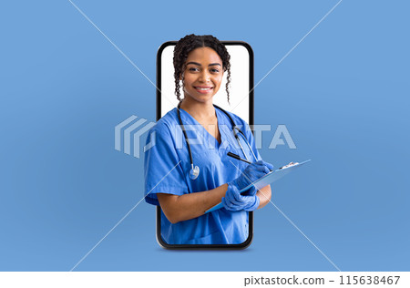 A cheerful black woman nurse dressed in blue scrubs writes on a clipboard while appearing to emerge from a smartphone screen, set against a light blue background. 115638467