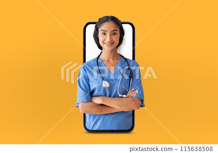 Indian lady medical professional in blue scrubs stands confidently with arms crossed, appearing through a smartphone screen, symbolizing telemedicine or digital healthcare innovation 115638508
