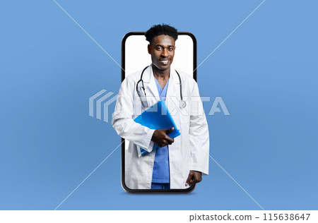 Black man doctor is seen holding a clipboard with medical notes displayed on a smartphone screen. The doctor appears engaged in reviewing or updating patient information using digital technology. 115638647