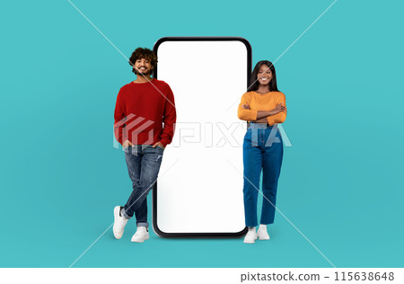 The duo, multiethnic man and woman, exhibit cheerful expressions next to an oversized smartphone mockup over colorful background The duo, multiethnic man and woman, exhibit cheerful expressions next to an oversized smartphone mockup over colorful background 115638648