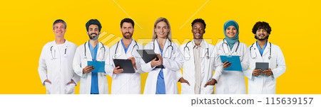 Happy adult, old diverse doctors professional in white coats with tablets, isolated on yellow studio background, panorama. Work in clinic, help online, medicine and health care Happy adult, old diverse doctors professional in white coats with tablets, isolated on yellow studio background, panorama. Work in clinic, help online, medicine and health care 115639157