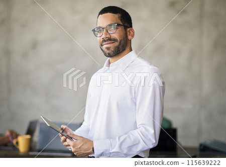 Business Manager. Portrait Of Successful Arabic Businessman In Eyeglasses Holding Digital Tablet Standing At Corporate Meeting In Office. Man In White Shirt Posing At Workplace. Career Concept 115639222