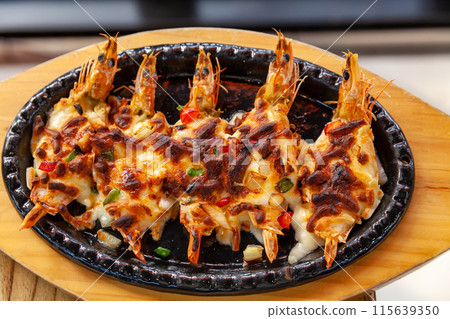 a dish that is grilled on a grill with cheese on shrimp, grilled shrimp with cheese a dish that is grilled on a grill with cheese on shrimp, grilled shrimp with cheese 115639350