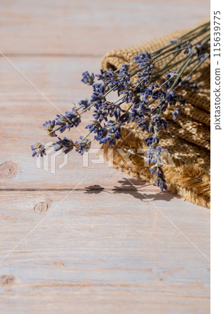 Dried lavender flowers on burlap textile material on wooden background. Copy space for your text. Advertisement mock up Dried lavender flowers on burlap textile material on wooden background. Copy space for your text. Advertisement mock up 115639775