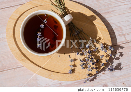 Healthy homemade cup of lavender tea. Organic natural home grown herb for teas. White cup of tea with dried lavender flowers. Healthy living wellbeing 115639776
