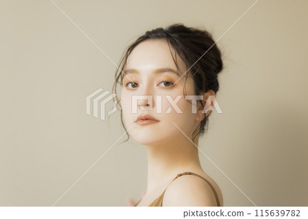 Young woman beauty image beige background 115639782