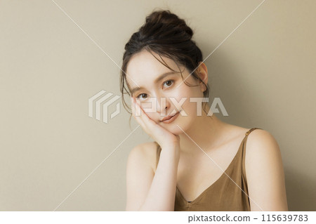 Young woman beauty image beige background 115639783