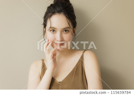 Young woman beauty image beige background 115639784