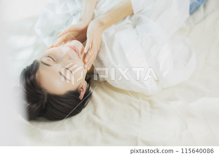 Woman lying on bed Woman lying on bed 115640086