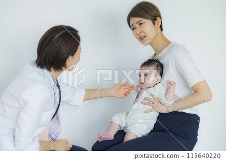 A female doctor examining a baby 115640220