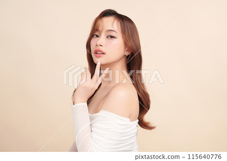Beautiful young asian woman with clean fresh skin on beige background, Face care, Facial treatment, Cosmetology, beauty and spa, Asian women portrait. 115640776
