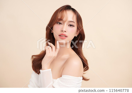 Beautiful young asian woman with clean fresh skin on beige background, Face care, Facial treatment, Cosmetology, beauty and spa, Asian women portrait. 115640778