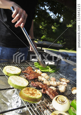 Hands of a man doing BBQ 1 115641215
