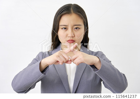 Young business woman making a cross gesture on white background 115641237