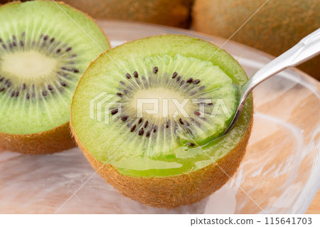 Eating juicy kiwi fruit with a spoon 115641703
