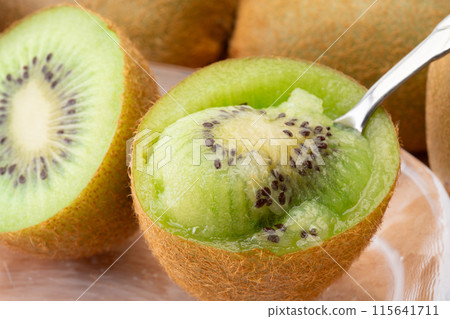 Eating juicy kiwi fruit with a spoon Eating juicy kiwi fruit with a spoon 115641711
