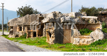 Rock burial chambers ruins in antique Lycian settlement of Araxa, Turkey 115641948