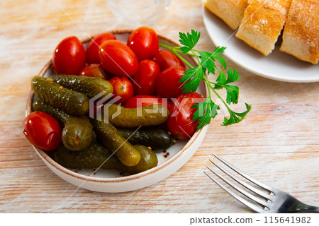 Appetizing pickled cucumbers and tomatoes Appetizing pickled cucumbers and tomatoes 115641982