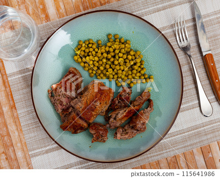 Pieces of roasted veal with canned green peas Pieces of roasted veal with canned green peas 115641986