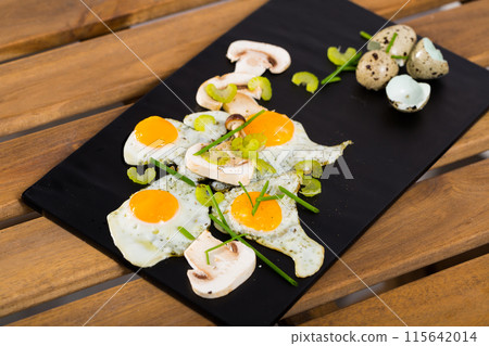 Fried quail eggs with champignons Fried quail eggs with champignons 115642014