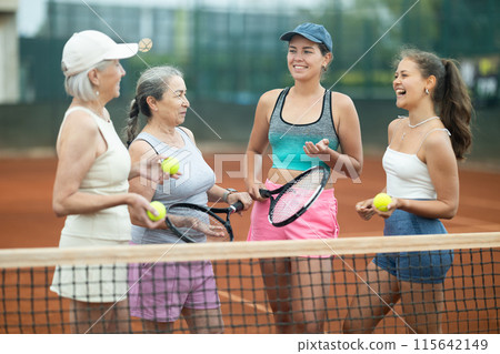 Group of women talking on tennis court 115642149