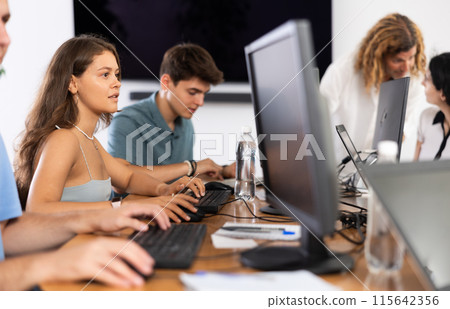 Motivated young female software developer working in IT startup Motivated young female software developer working in IT startup 115642356