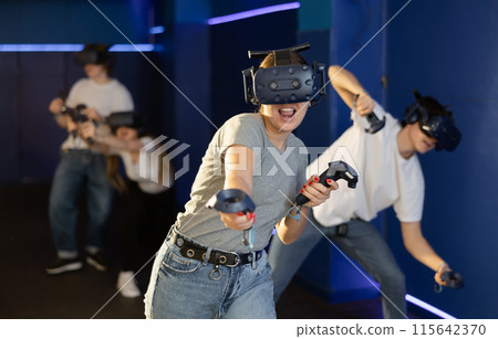 girl in virtual reality helmet crouches down and dodges flying asteroids during space adventure game 115642370