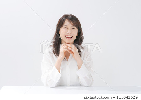 A smiling middle-aged woman with a cane 115642529