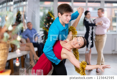 Group of people having fun celebrating Christmas and dancing waltz or tango 115642595