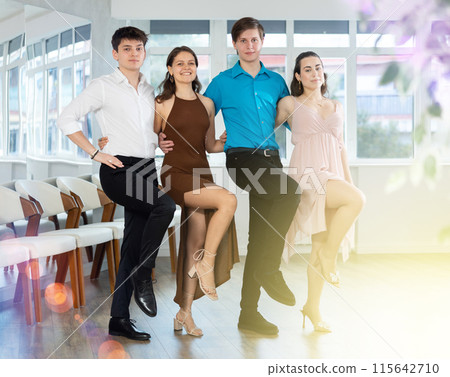 Girls and guy dancing folk dance in row in dance studio Girls and guy dancing folk dance in row in dance studio 115642710