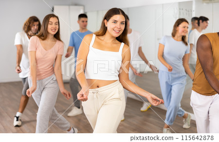 Women and man performing modern dance in fitness studio 115642878