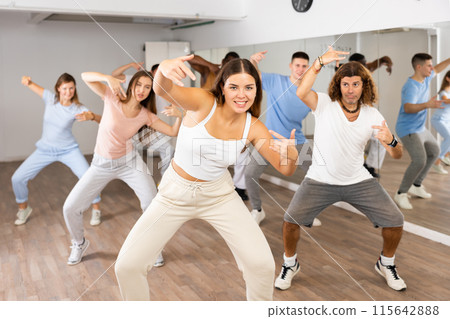 Group of different people rehearsing dance in dance studio Group of different people rehearsing dance in dance studio 115642888