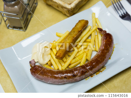 Rustic sausage with fried potato served at plate with sauce Rustic sausage with fried potato served at plate with sauce 115643016