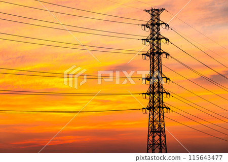 A row of power transmission towers and a sunset sky with thin clouds d-3 Warm colors, high contrast 115643477