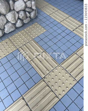 Braille blocks installed in front of the wall 115643633