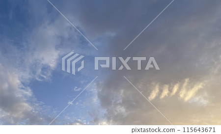 The Mesmerizing Dance of Dramatic Clouds in the Sky at Dawn's Early Hours.The Dramatic Movement of Clouds in the Sky During the Early Hours of Dawn. 115643671