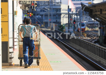 Station staff carrying luggage on the Shinkansen platform Station staff carrying luggage on the Shinkansen platform 115643750