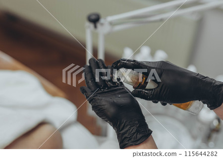 cream in the hands of a cosmetologist cream in the hands of a cosmetologist 115644282