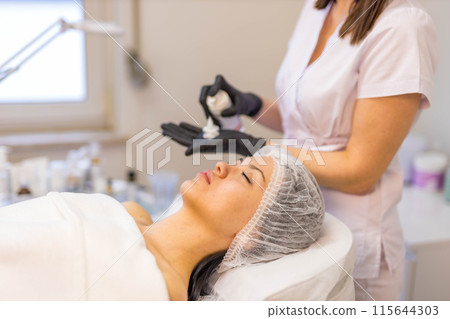 A cosmetologist-esthetician treats problem skin A cosmetologist-esthetician treats problem skin 115644303