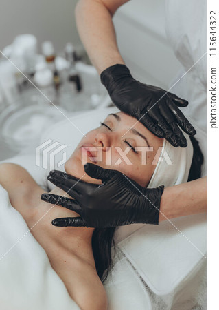 woman at the cosmetologist. She has problem skin and acne. 115644322