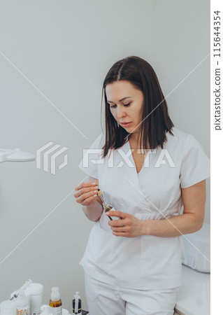 A woman doctor is a cosmetologist in her beauty salon 115644354