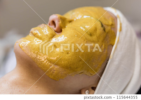 A girl at a cosmetologist does cosmetic procedures. Alginate mask A girl at a cosmetologist does cosmetic procedures. Alginate mask 115644355
