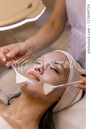 A girl at a cosmetologist does cosmetic procedures. Skin cleansing A girl at a cosmetologist does cosmetic procedures. Skin cleansing 115644724