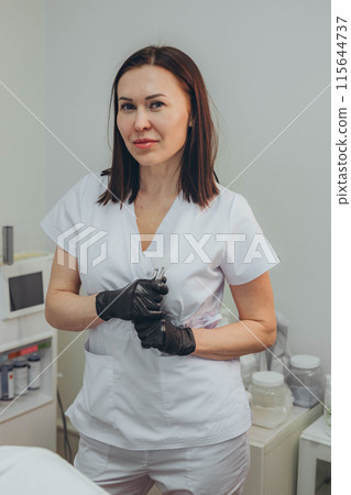 Cosmetologist esthetician performs skin treatment and rejuvenation 115644737